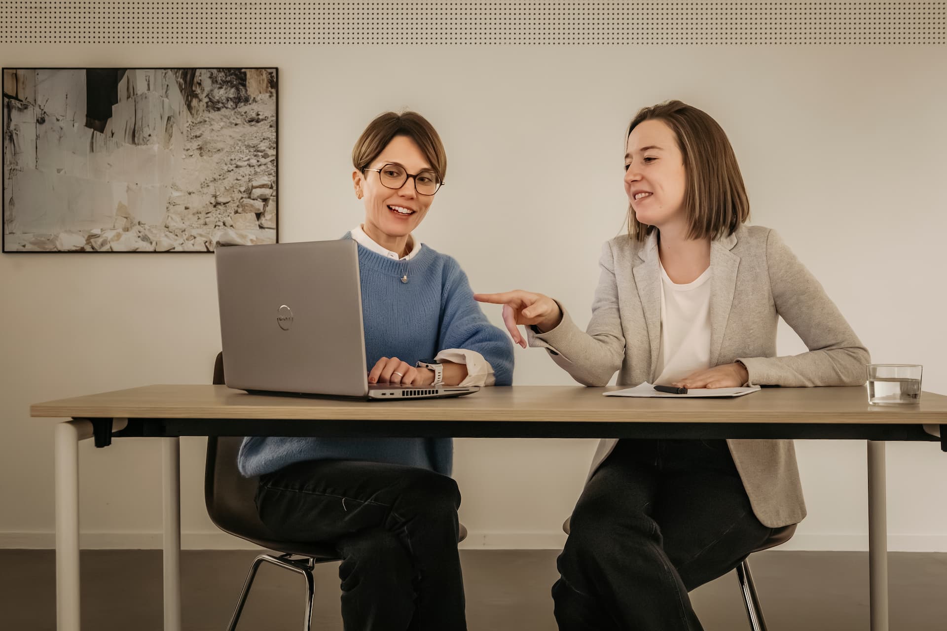 man and woman sitting at desk